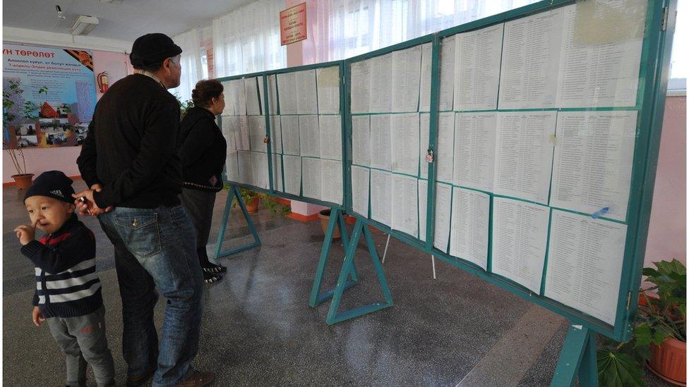 Voters studying electoral rolls before polling day; voters lists have been compiled using biometric data for verification at each polling station