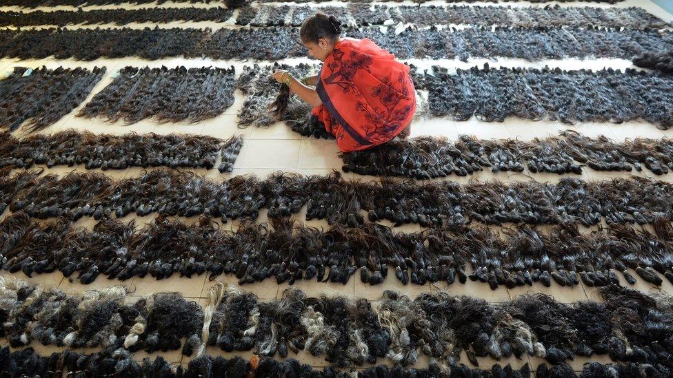 A worker at a hair processing plant in India