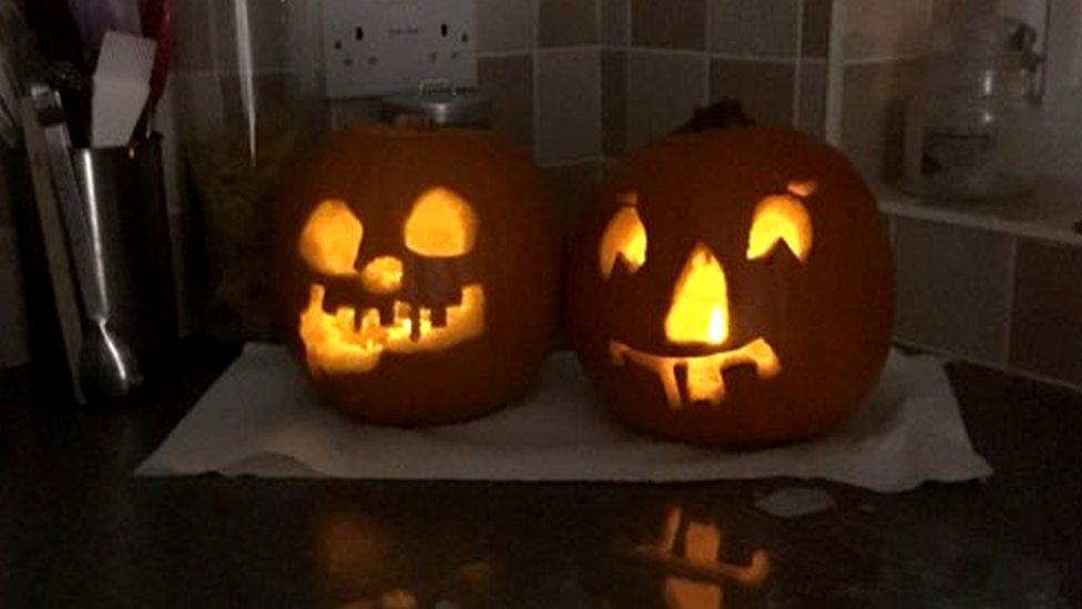 Faces carved into two pumpkins