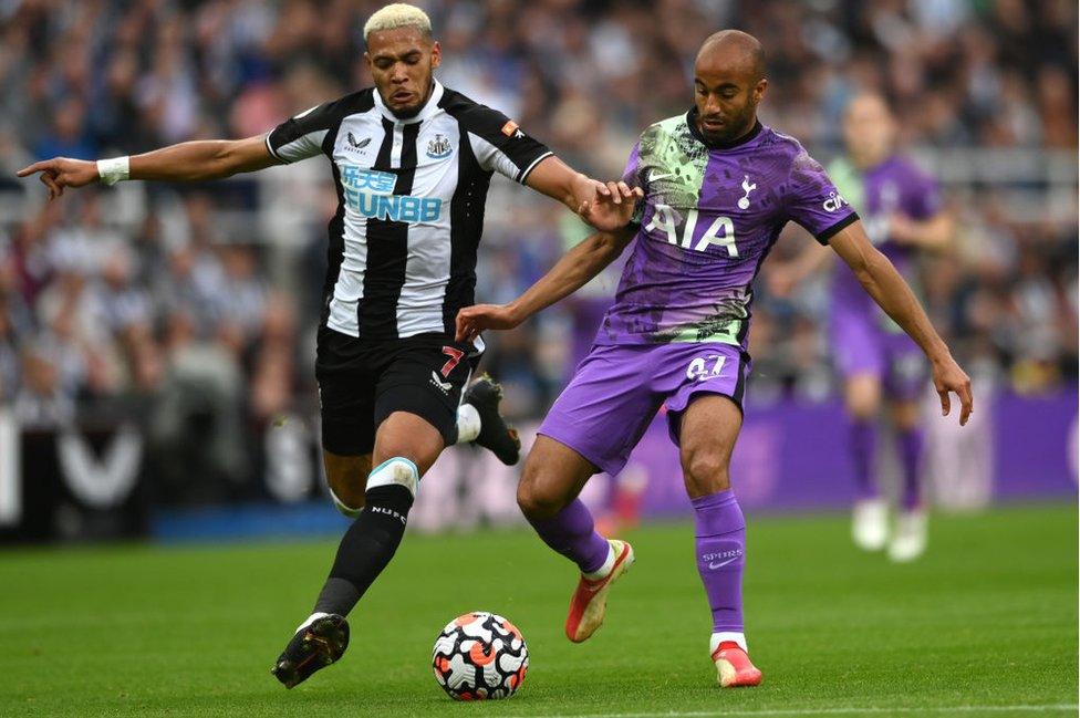 Joelinton of Newcastle and Lucas Moura of Spurs compete for the ball