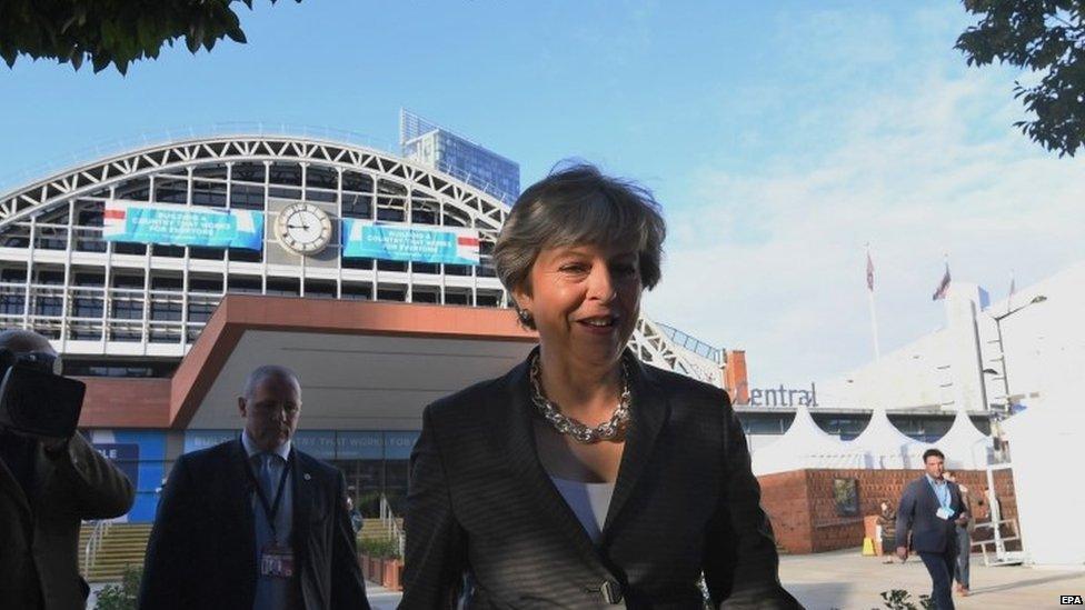 Theresa May outside the conference hall in Manchester