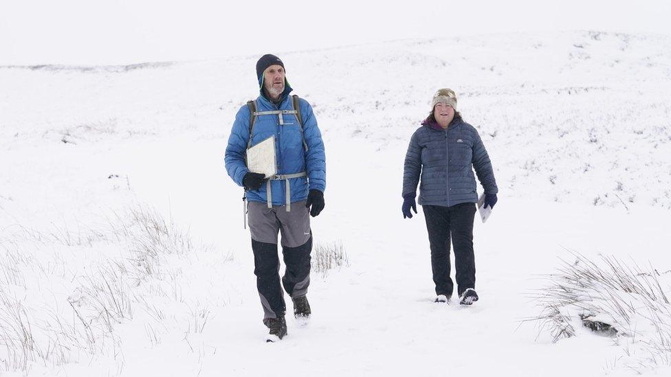 Man and woman walking in snow