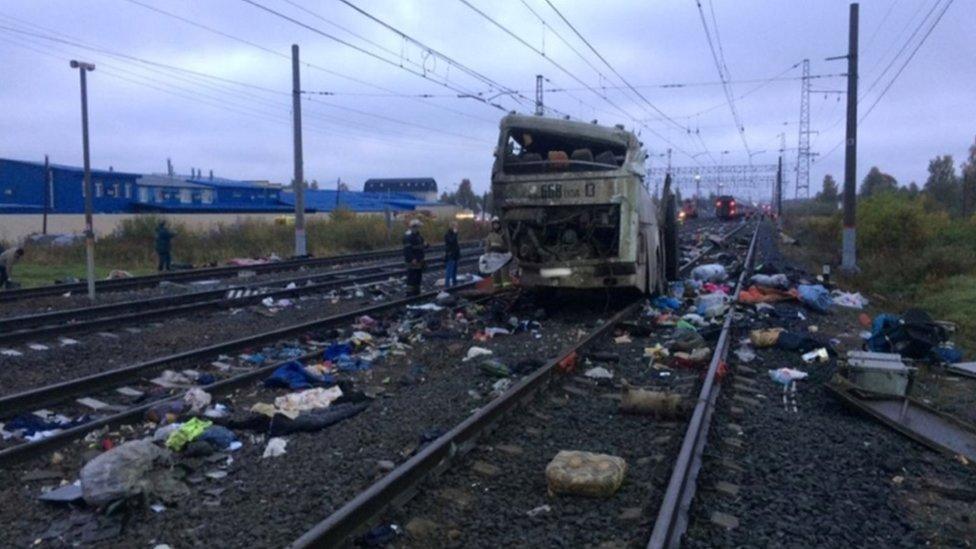 The other half of bus can be seen with passengers belongings surrounding