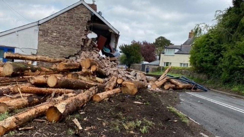 Timber and the house strewn across the road