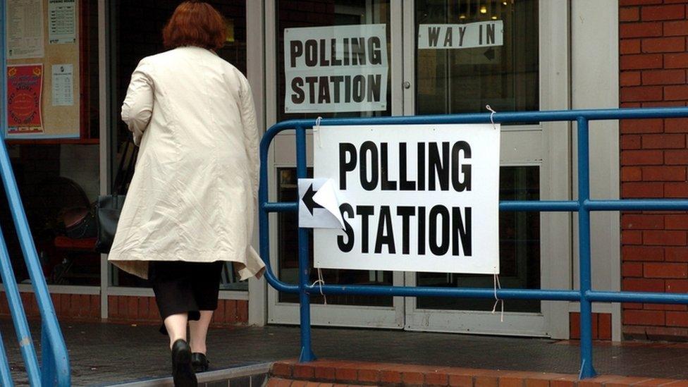 Woman entering polling station