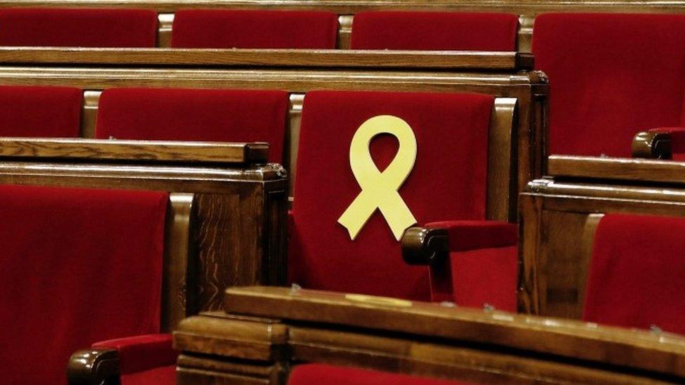 Catalan parliament chair with symbol remembering those in jail