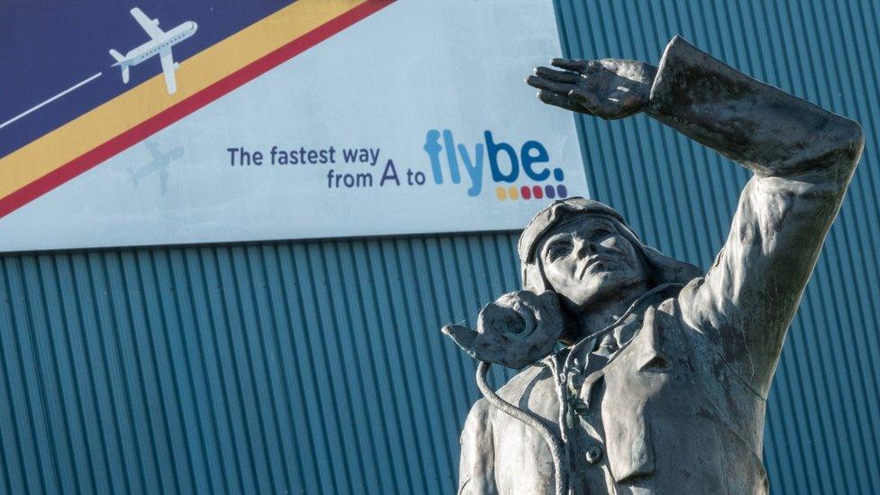 Aviator in front of Flybe sign