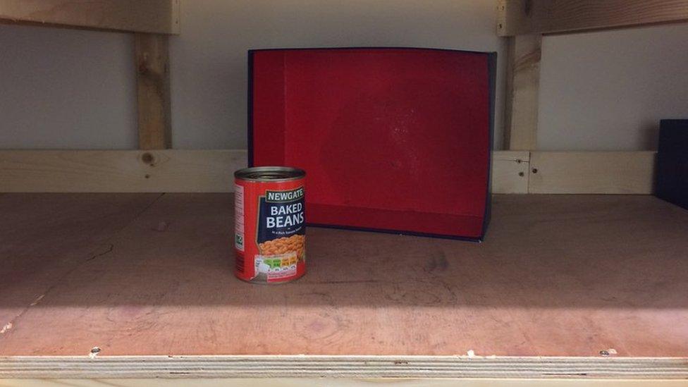 A shelf with just one tin of beans