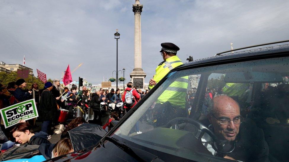 The driver of a hearse attached to the wheel with a bicycle lock