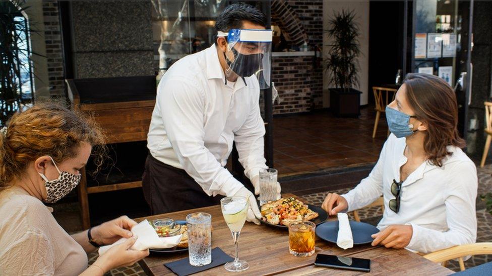 Waiter serving customer