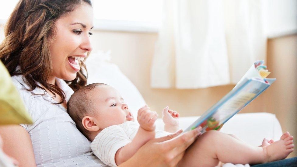 mum reading to baby