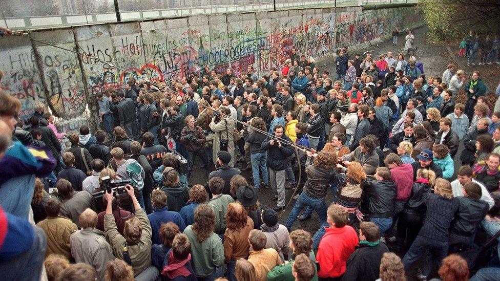 Berlin Wall being pulled down.