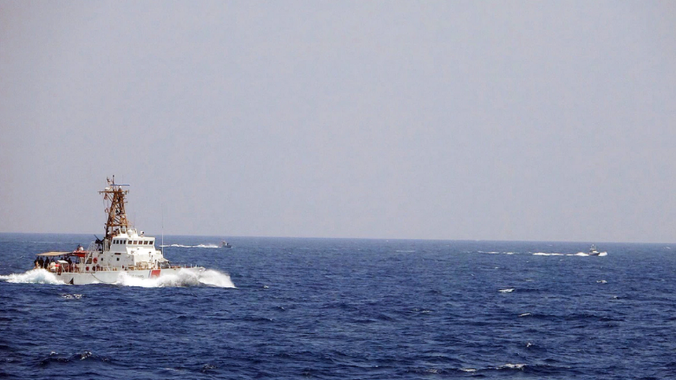 Two Iranian craft come close to the USCGC Maui as it transits the Strait of Hormuz