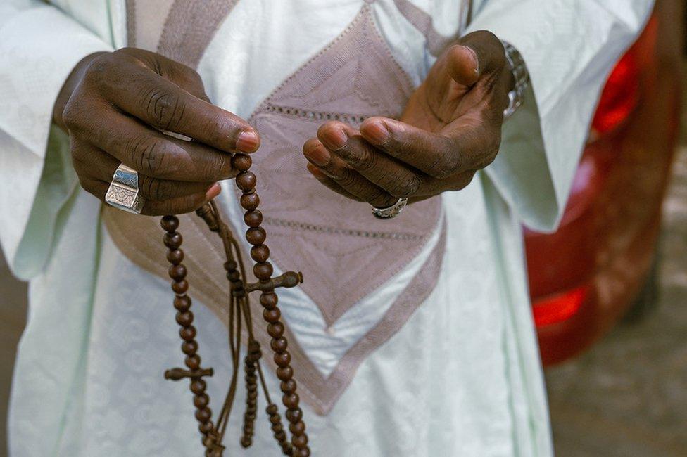 Mamadou Diokhame carries prayer beads in his hands