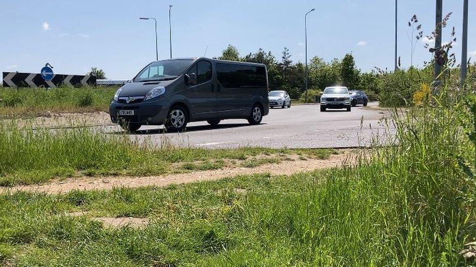 Cars at the roundabout to Longwater Retail Park