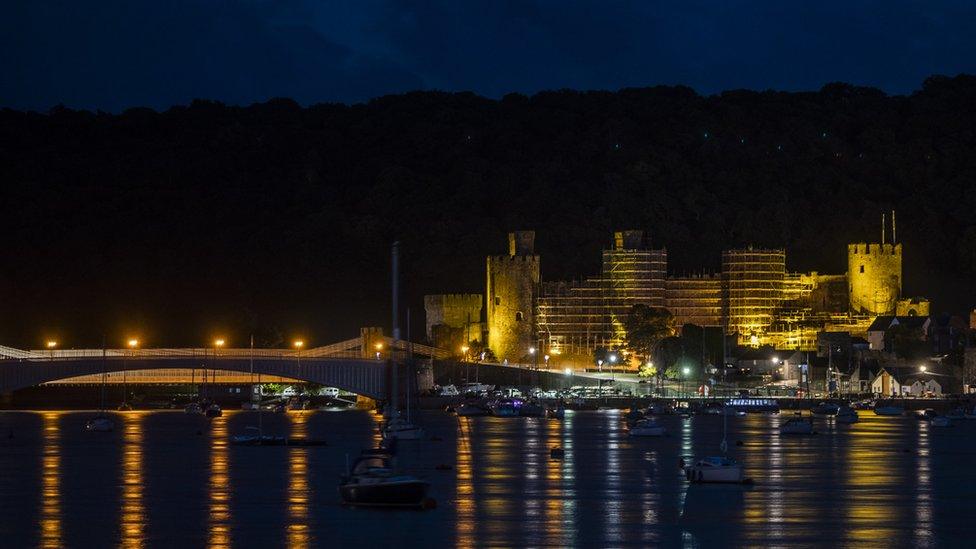 Conwy Castlew lit up in yellow