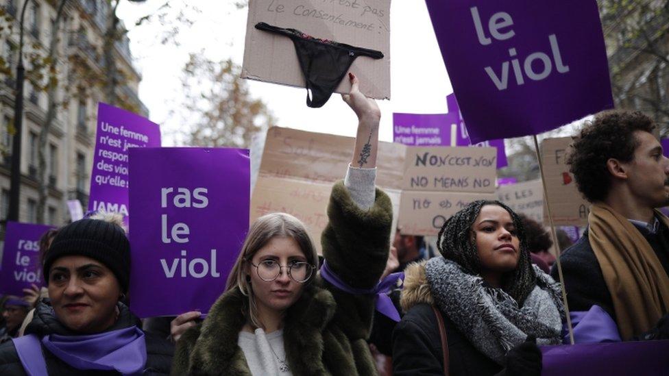 A woman holds a placard displaying a female's underwear reading: "This is not my consent" during a rally against sexual violence against women