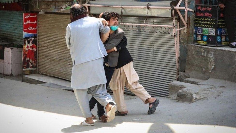 6 An Afghan man reacts at the scene after an attack at MSF (Doctors without Borders) clinic in Kabul, Afghanistan, 12 May 2020.