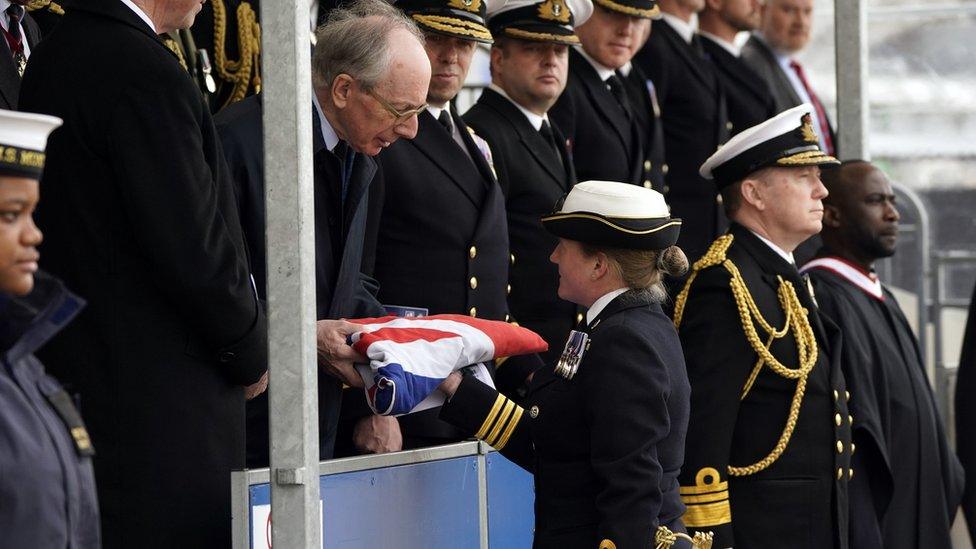 Commanding officer Commander Claire Thompson (right) hands over the White Ensign to Sir Malcolm Rifkind, whose late wife Lady Edith was the sponsor of HMS Montrose