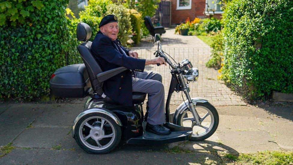 Former soldier Ralph Harvey, 89, drives his mobility scooter during celebrations for the 75th anniversary of VE Day on May 08, 2020 in Redcar, United Kingdom