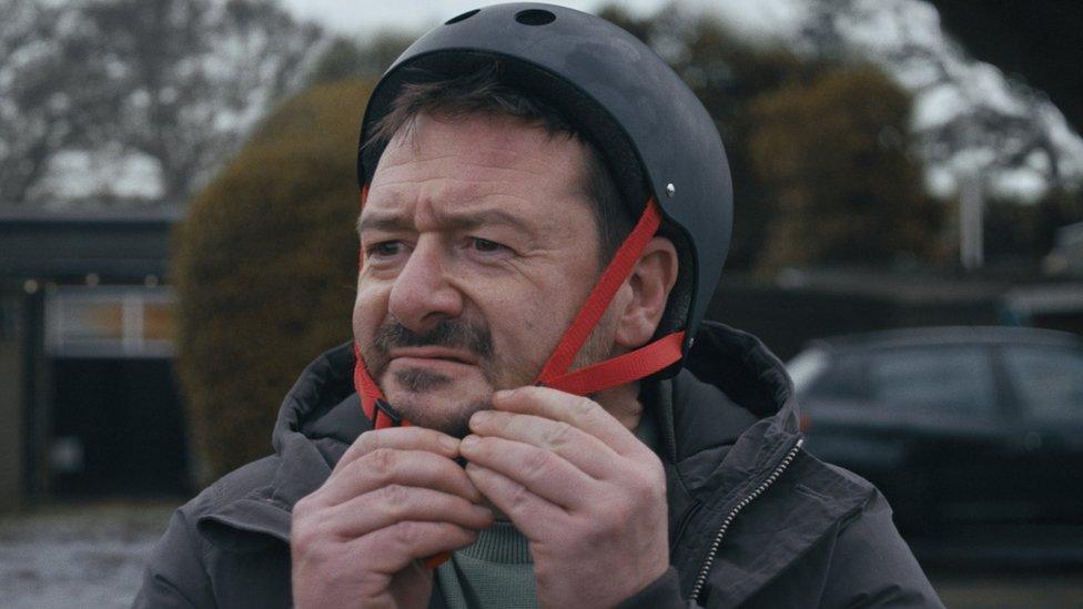 A picture of a man learning to skateboard from the John Lewis Christmas ad.