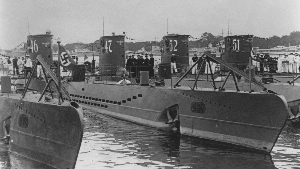 U-47, a Type VIIB U-boat submarine of the German navy (Kriegsmarine) while tied up alongside the U-46, U-52 and U-51 Unterseeboot at the Germaniawerft naval base on 1 August 1939 in Kiel, Germany