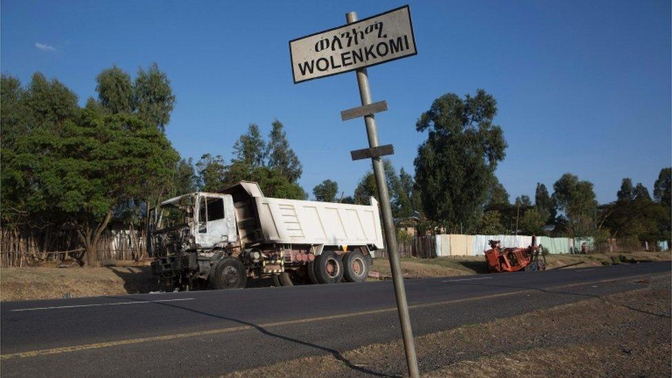 A burnt out truck, assumed to be set fire by protesters, lies outside the village of Wolenkomi