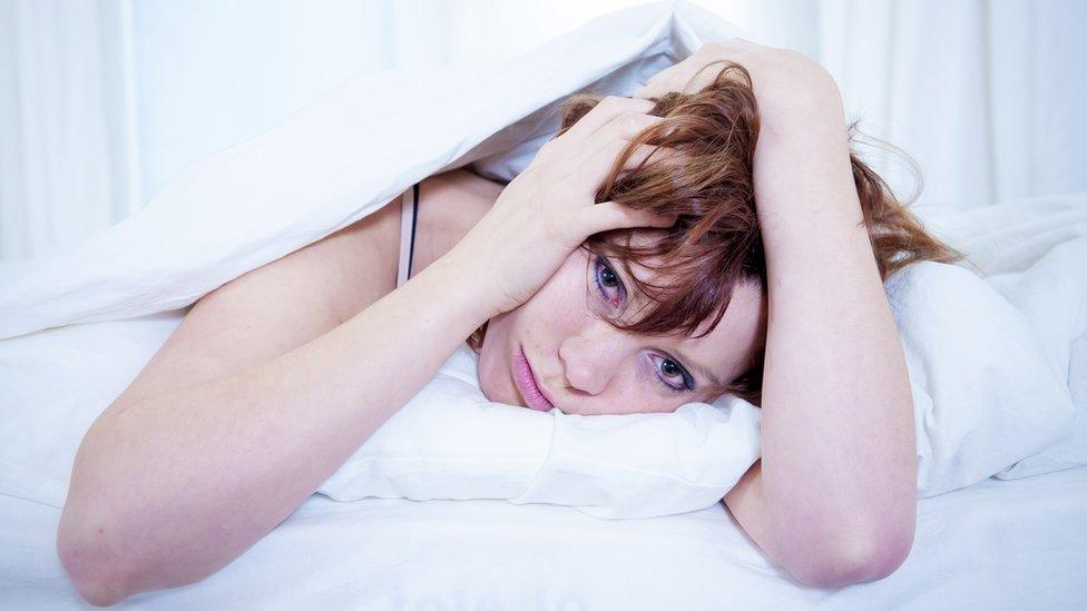 Woman awake in bed