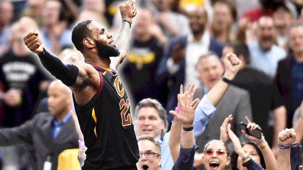 LeBron James celebrating with a crowd behind him