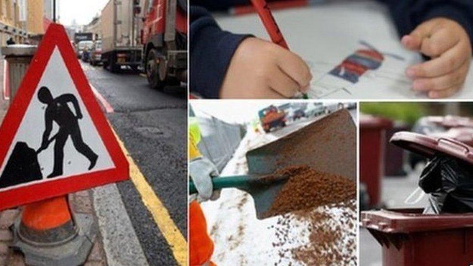 Traffic sign, child writing, road being dug up, and bins waiting to be emptied