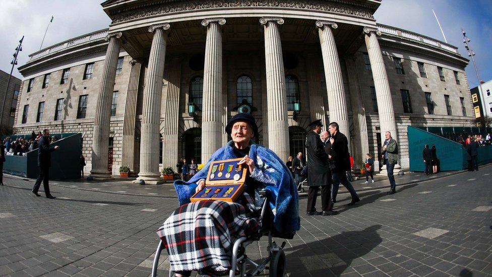 Sheila O"Leary, 94, from Clontarf, whose father Thomas Byrne fought in the GPO in 1916, holds a box of his medals on O'Connell Street