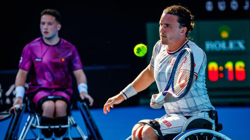 Alfie hewett in background, out of focus, gordon reid in foreground, in focus