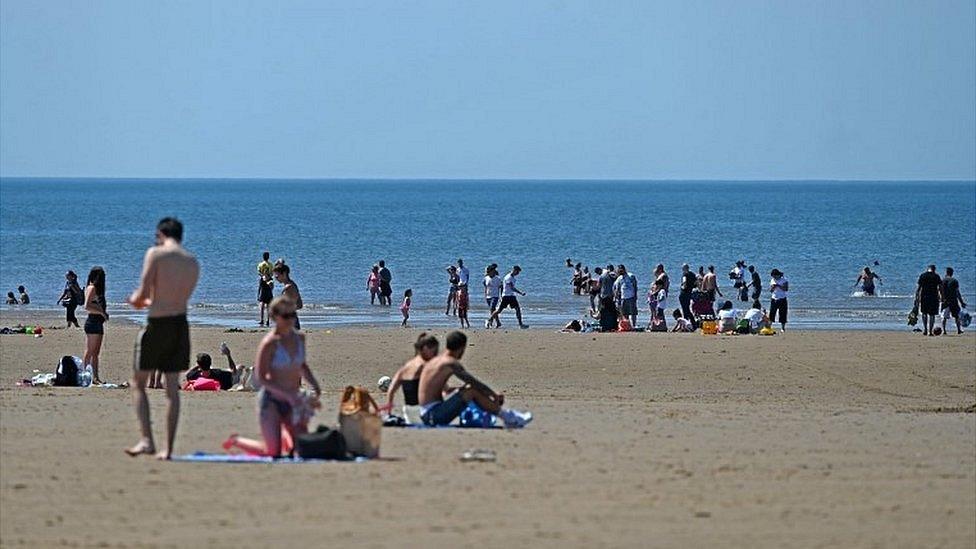 People sunbathing on Blackpool beach