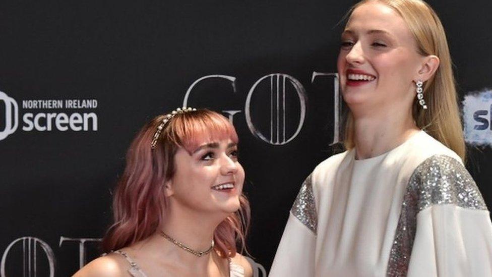 Maisie Williams and Sophie Turner share a laugh at the premiere