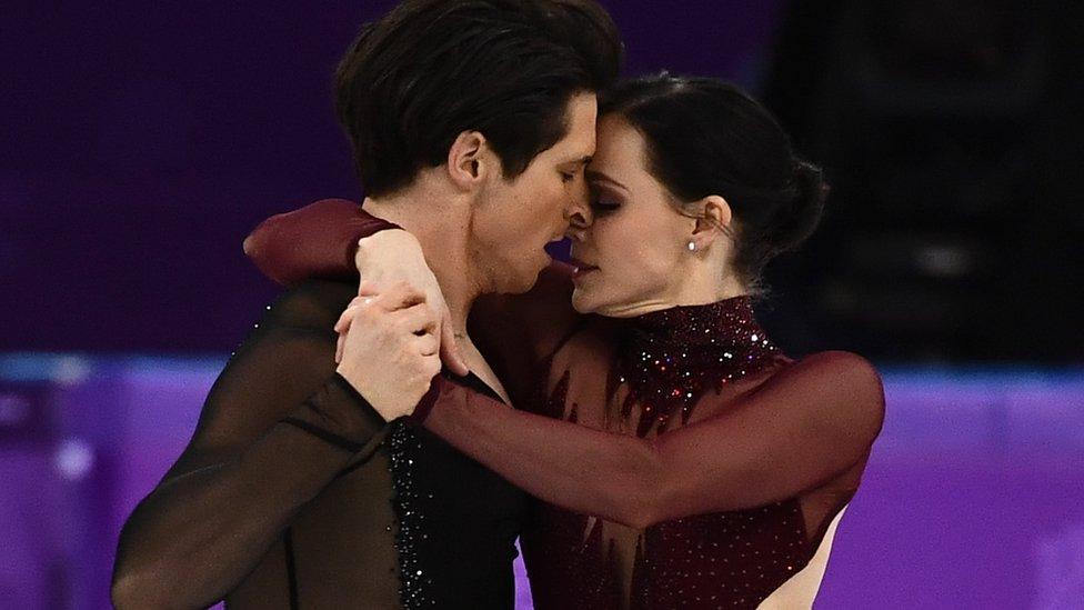 Canadians Tessa Virtue and Scott Moir locked in tight, face-to-face embrace while skating