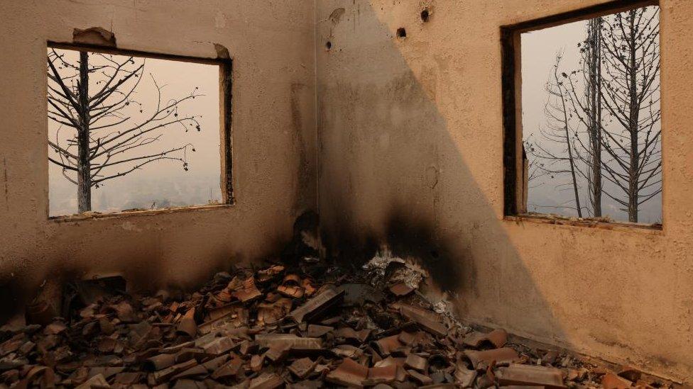 A view of a destroyed house as a wildfire burns in the village of Avantas, near Alexandroupolis, in the region of Evros, Greece, August 22, 2023