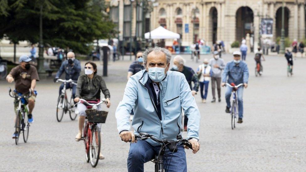 People ride bicycles outdoors on the first Sunday of Phase 2 during the coronavirus emergency, in Verona, northern Italy, 10 May 2020