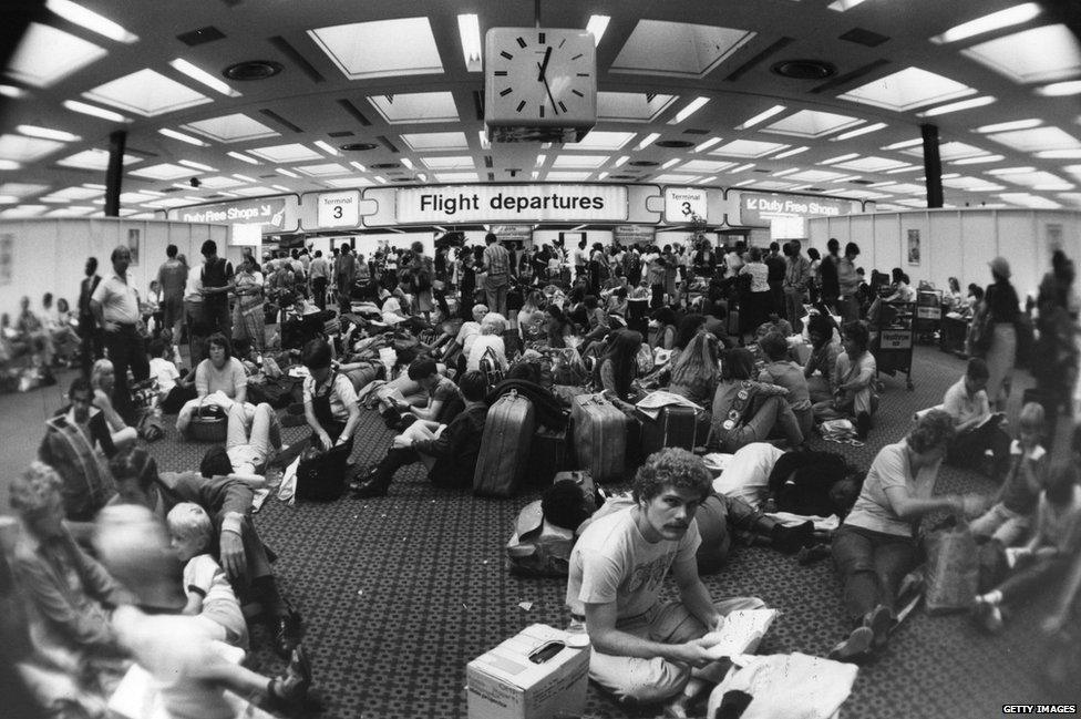 Holiday-makers waiting in the departure lounge at Terminal Three of London's Heathrow airport, during delays caused by industrial action taken by Canadian air traffic controllers, 1981