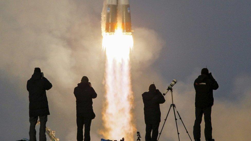 Photographers taking pictures of the Soyuz spacecraft launch