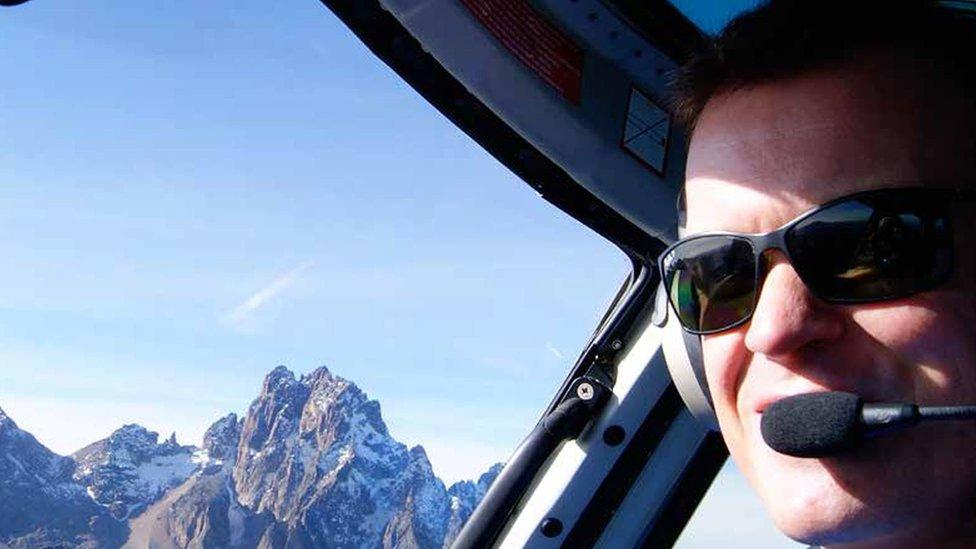 Pilot Roger Gower piloting a helicopter for Tropic Air Kenya, from its base in Kenya.