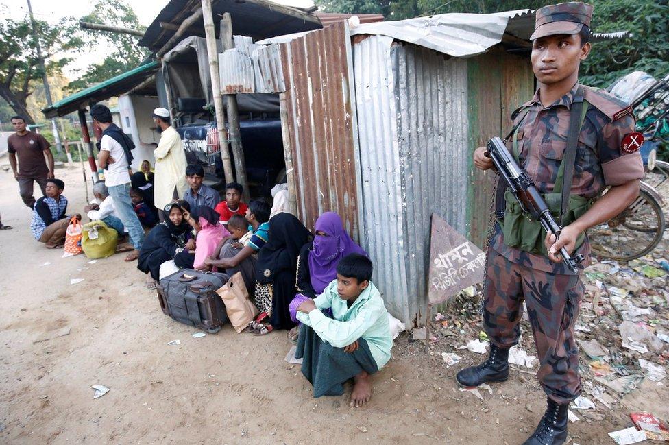 Policeman stands guard after catching Rohingya Muslims illegally crossing at a border check point in Cox's Bazar, Bangladesh, November 21, 2016