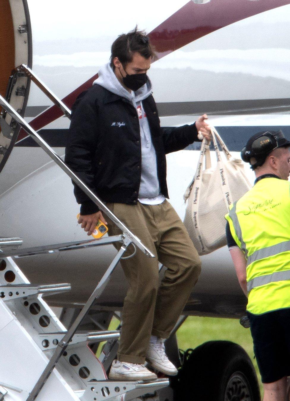 Harry Styles arrives at Glasgow Airport by private jet