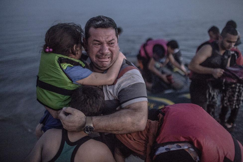 Laith Majid, holding his son and daughter in his arms