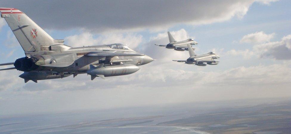 An RAF Tornado F3 Navigator escorts Typhoon jets as they fly over the Falkland Islands