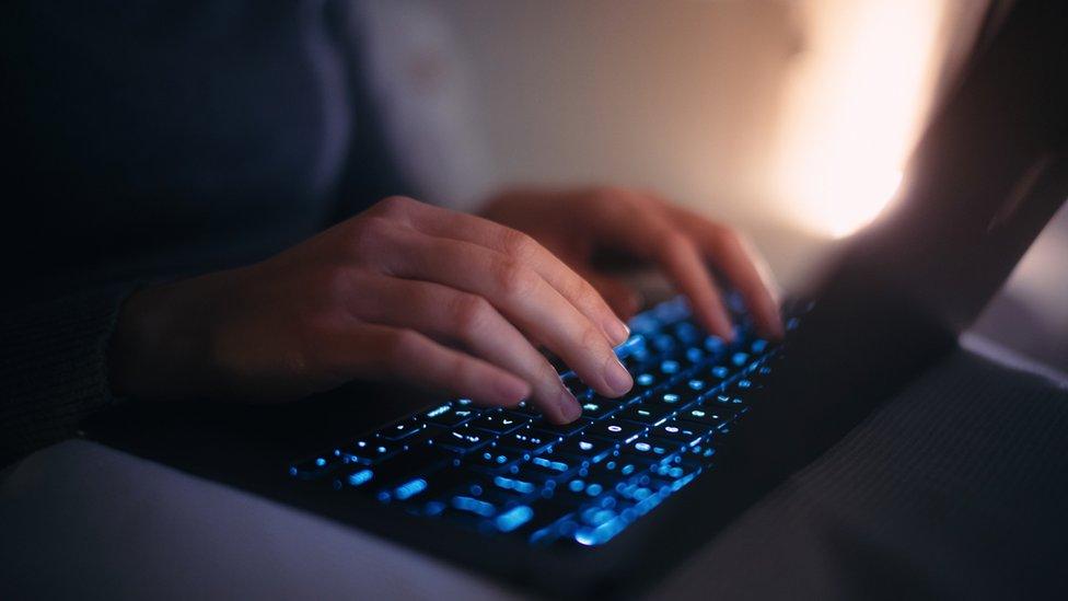 Woman's hands typing on keyboard