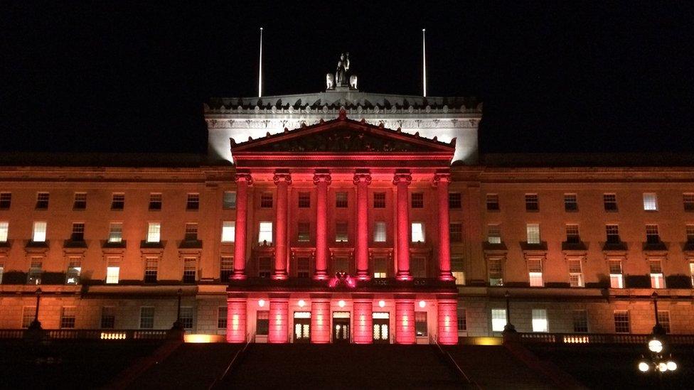 Parliament Buildings illuminated in red for Armistice Day