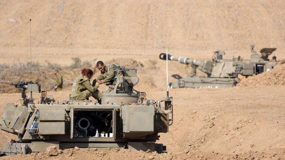 sraeli soldiers with armoured fighting vehicles at an area along the border with Gaza