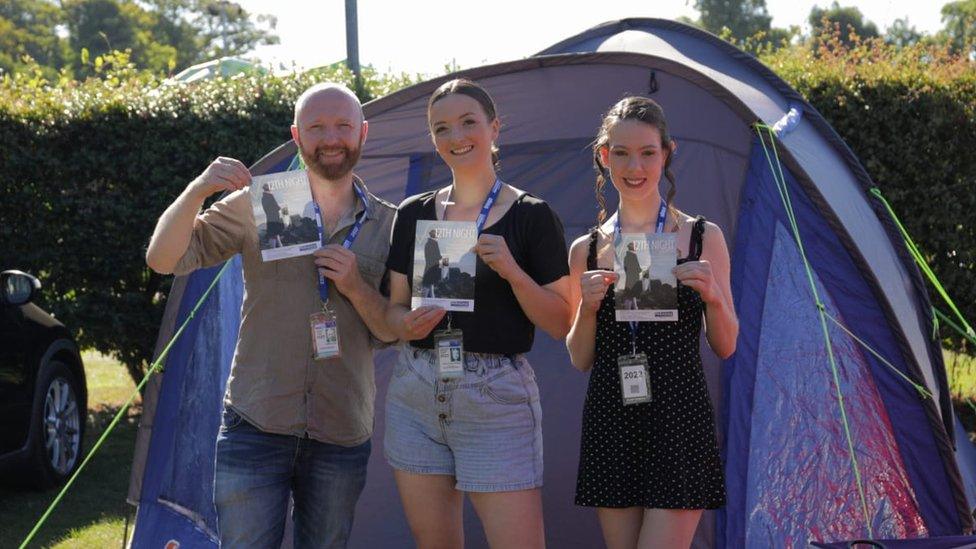 A picture of the performers outside their tent