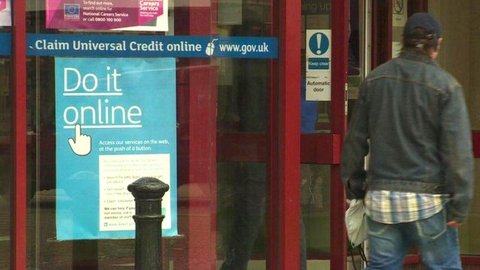 Universal Credit poster in window