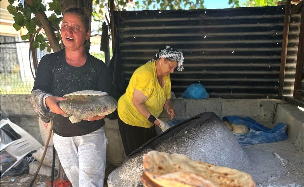 Hulya Yesiloglu bakes flatbreads using a wood-burning oven beside her home